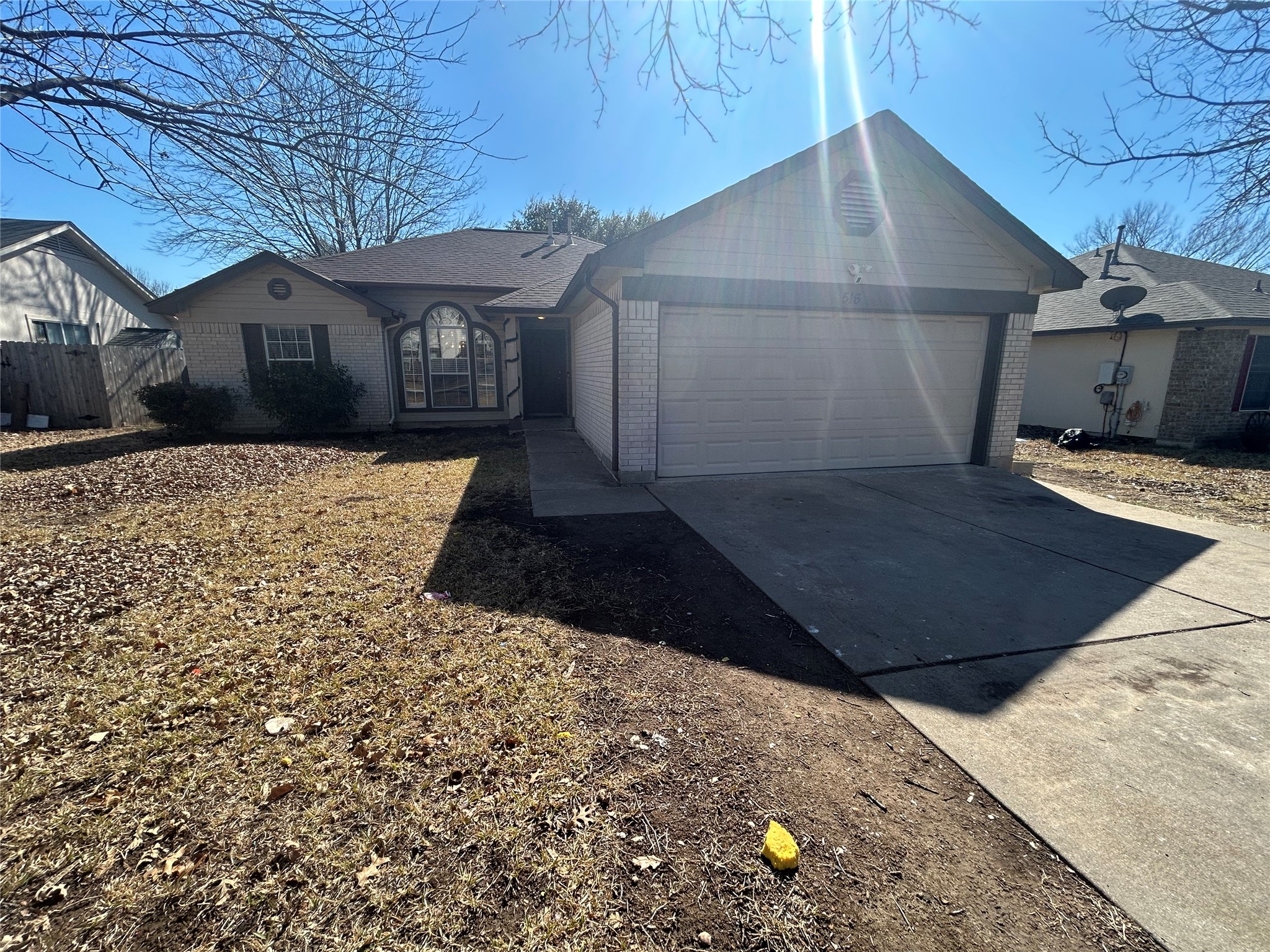 Ranch-style house with brick siding, driveway, and an attached garage