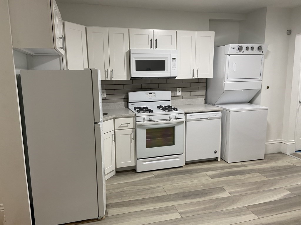 252 Windsor Street, Unit 3 Cambridge, MA 02139 - Photo 1 of 21 a kitchen with white cabinets and white appliances