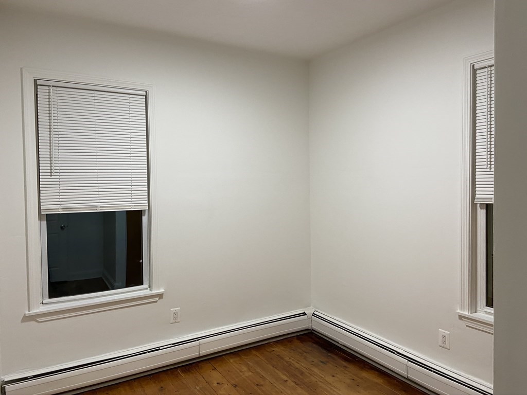 252 Windsor Street, Unit 3 Cambridge, MA 02139 - Photo 19 of 21 a view of a small space with wooden floor and a window