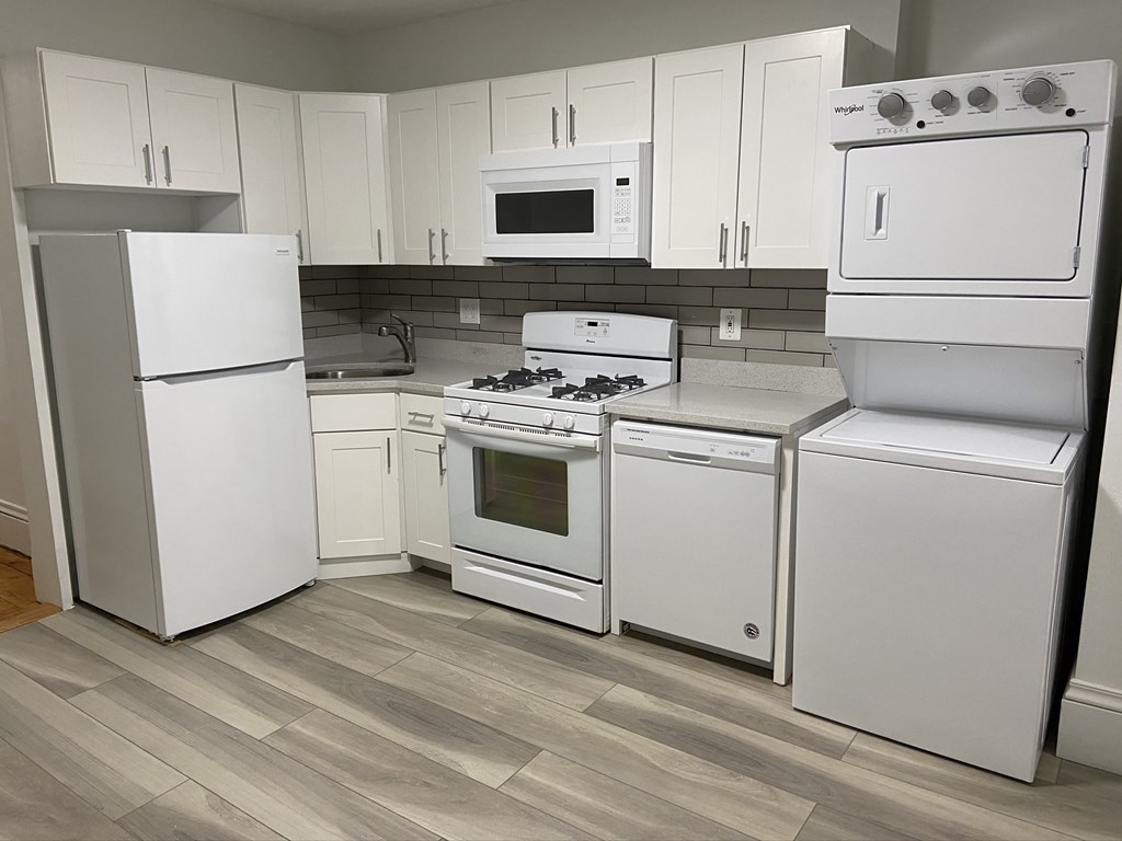 252 Windsor Street, Unit 3 Cambridge, MA 02139 - Photo 4 of 21 a kitchen with cabinets appliances and wooden floor