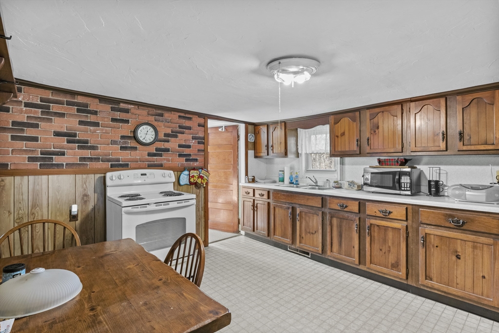 7 Wendover Road Holden, MA 01520 - Photo 5 of 28 a kitchen with stainless steel appliances granite countertop a sink a stove and a refrigerator