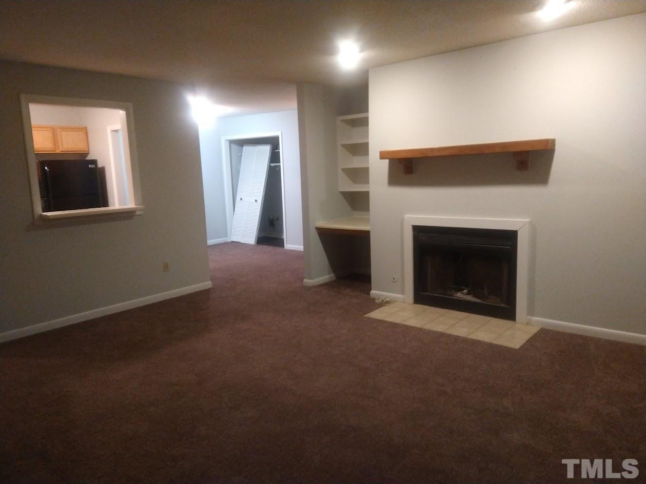 a view of empty room with fireplace