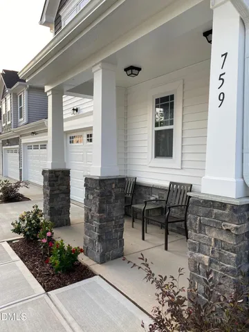 a view of backyard with seating space and potted plants
