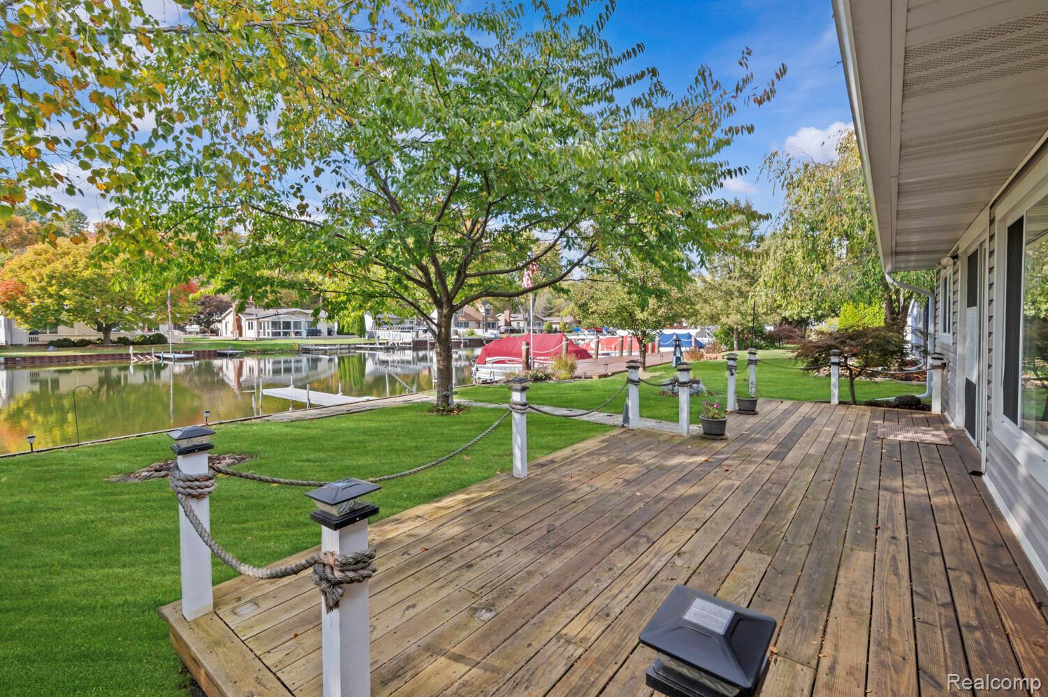 11026 Colony Pinckney, MI 48169 - Photo 35 of 40 Wooden deck with a water view, a lawn, and a residential view