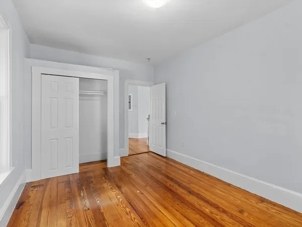 a view of room with wooden floor