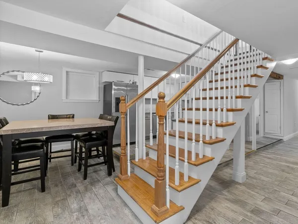 a view of entryway dining room and hall with wooden floor