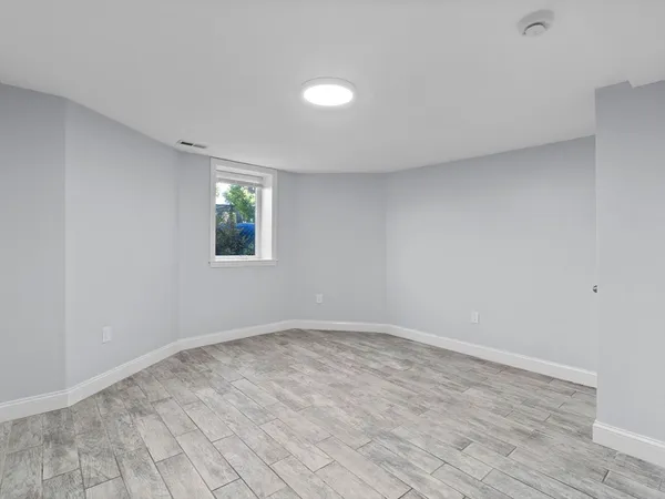 wooden floor in an empty room with a window