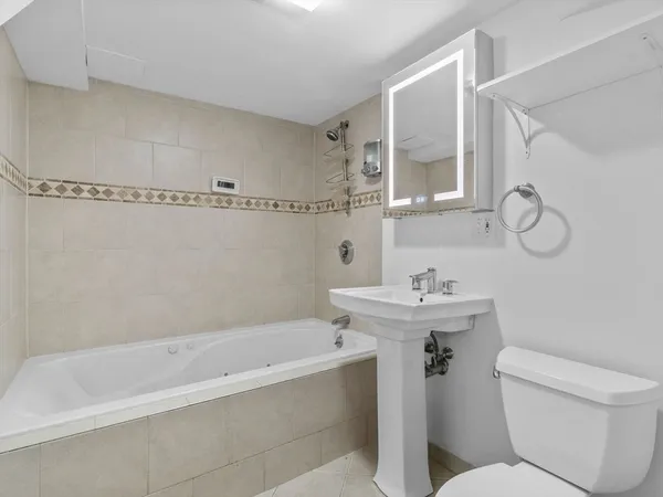 a bathroom with a sink a toilet and a bathtub