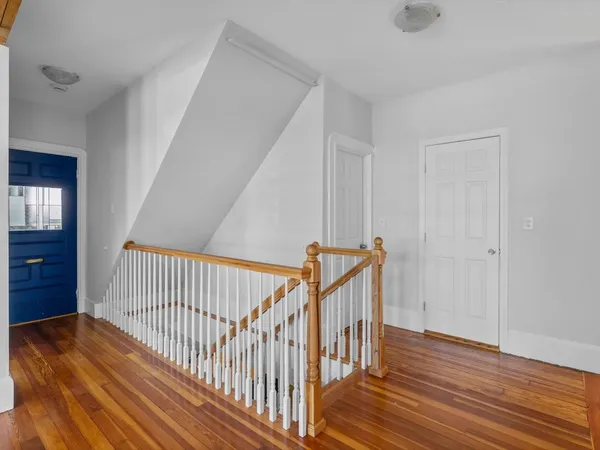 a view of hallway with wooden floor