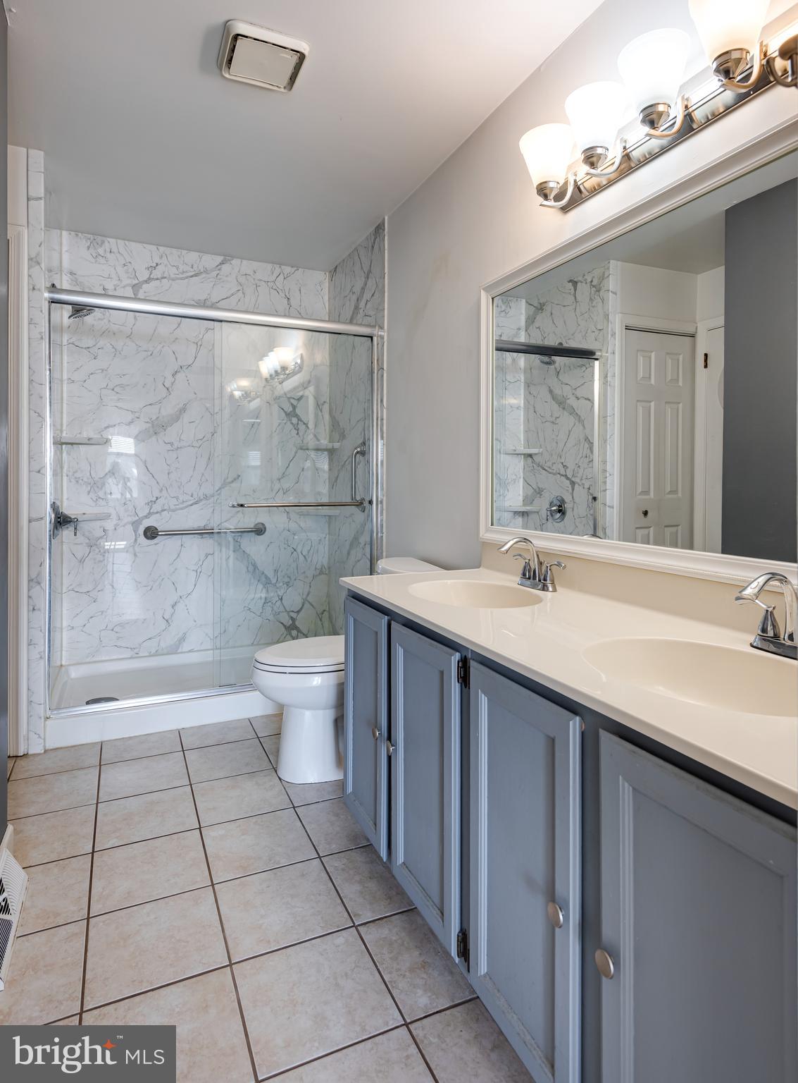5005 Farming Ridge Boulevard Reading, PA 19606 - Photo 16 of 25 a bathroom with a sink a toilet and shower