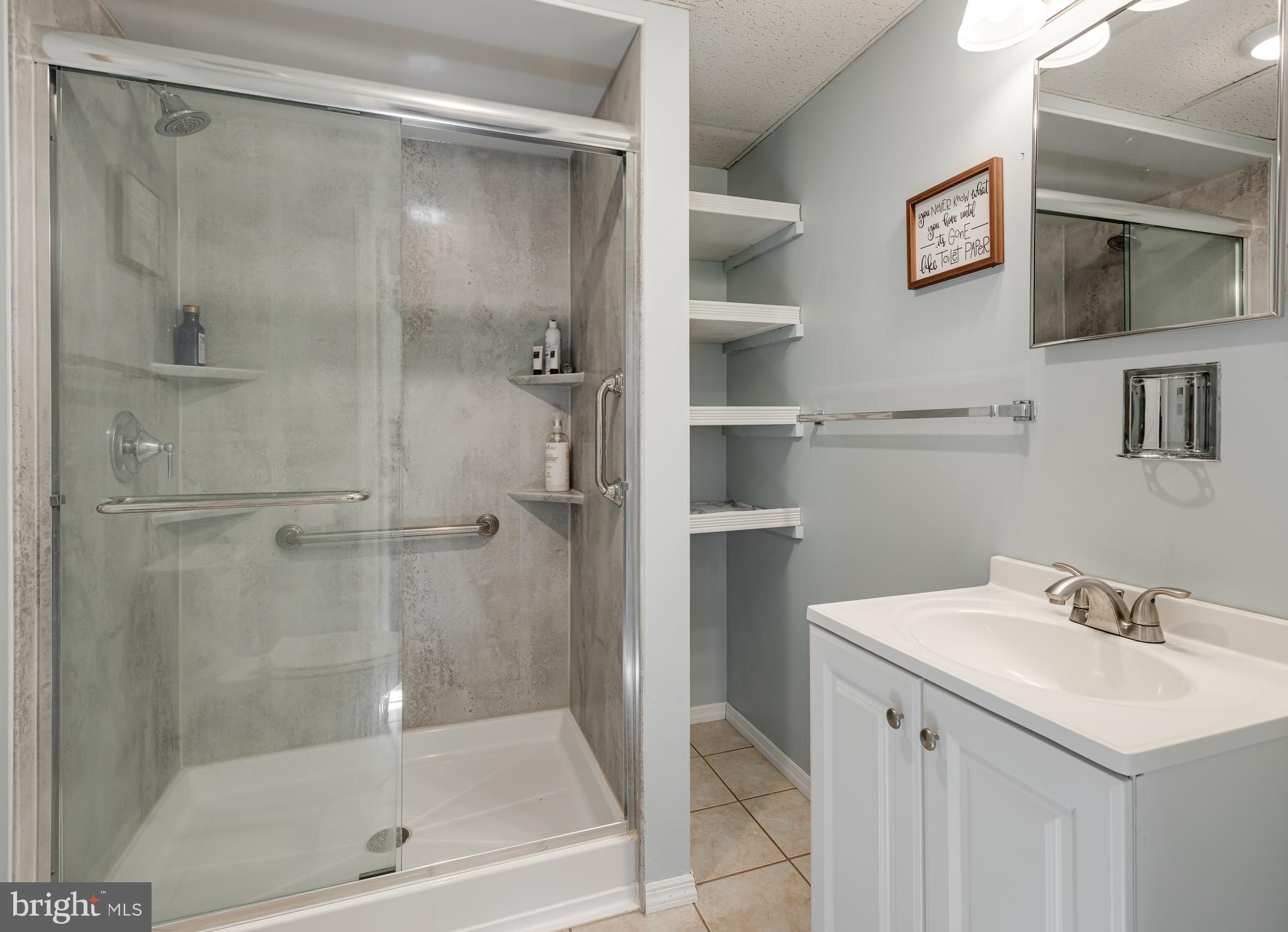 5005 Farming Ridge Boulevard Reading, PA 19606 - Photo 21 of 25 a bathroom with a shower sink vanity and mirror