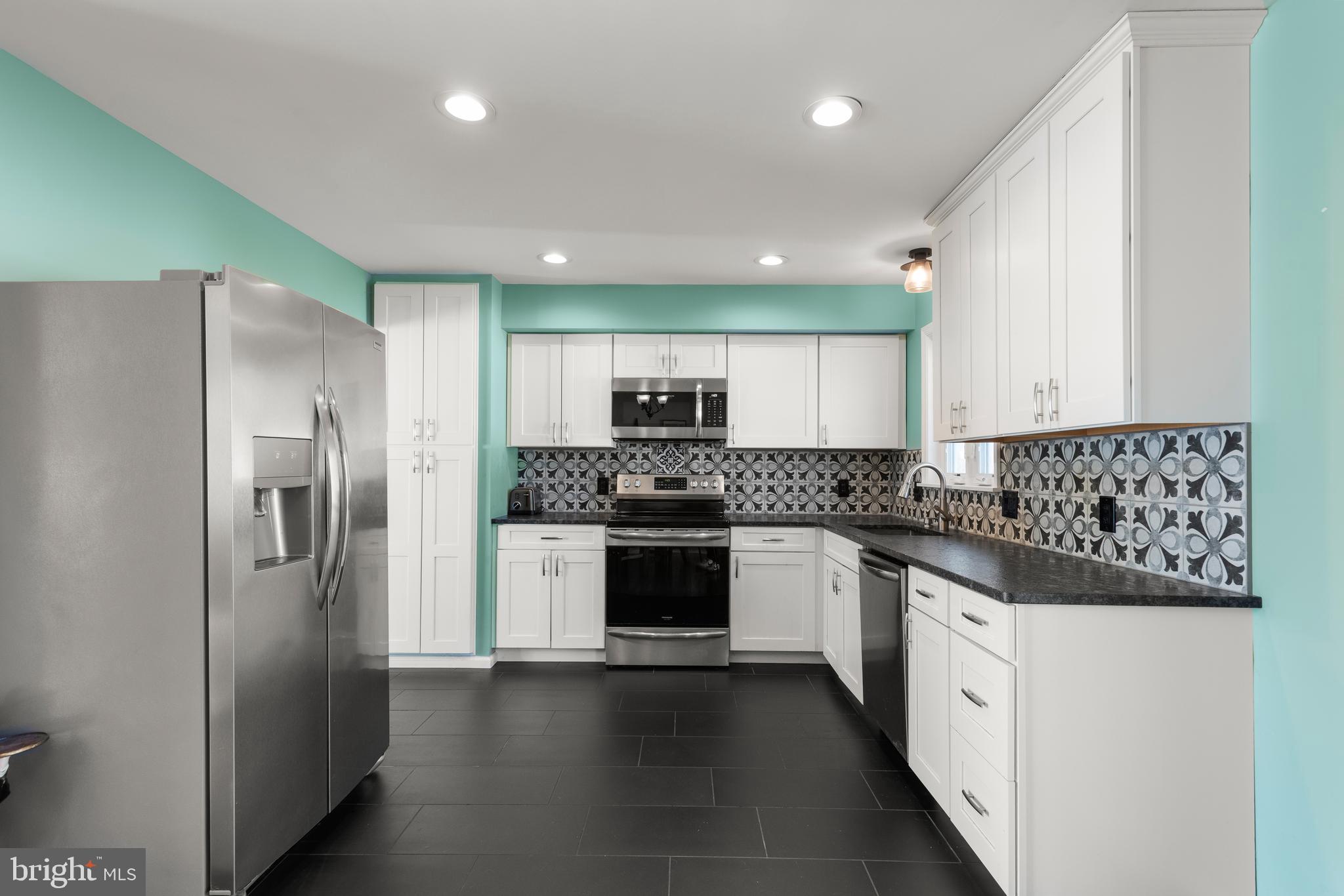 5005 Farming Ridge Boulevard Reading, PA 19606 - Photo 6 of 25 a kitchen with stainless steel appliances granite countertop a refrigerator and a stove top oven