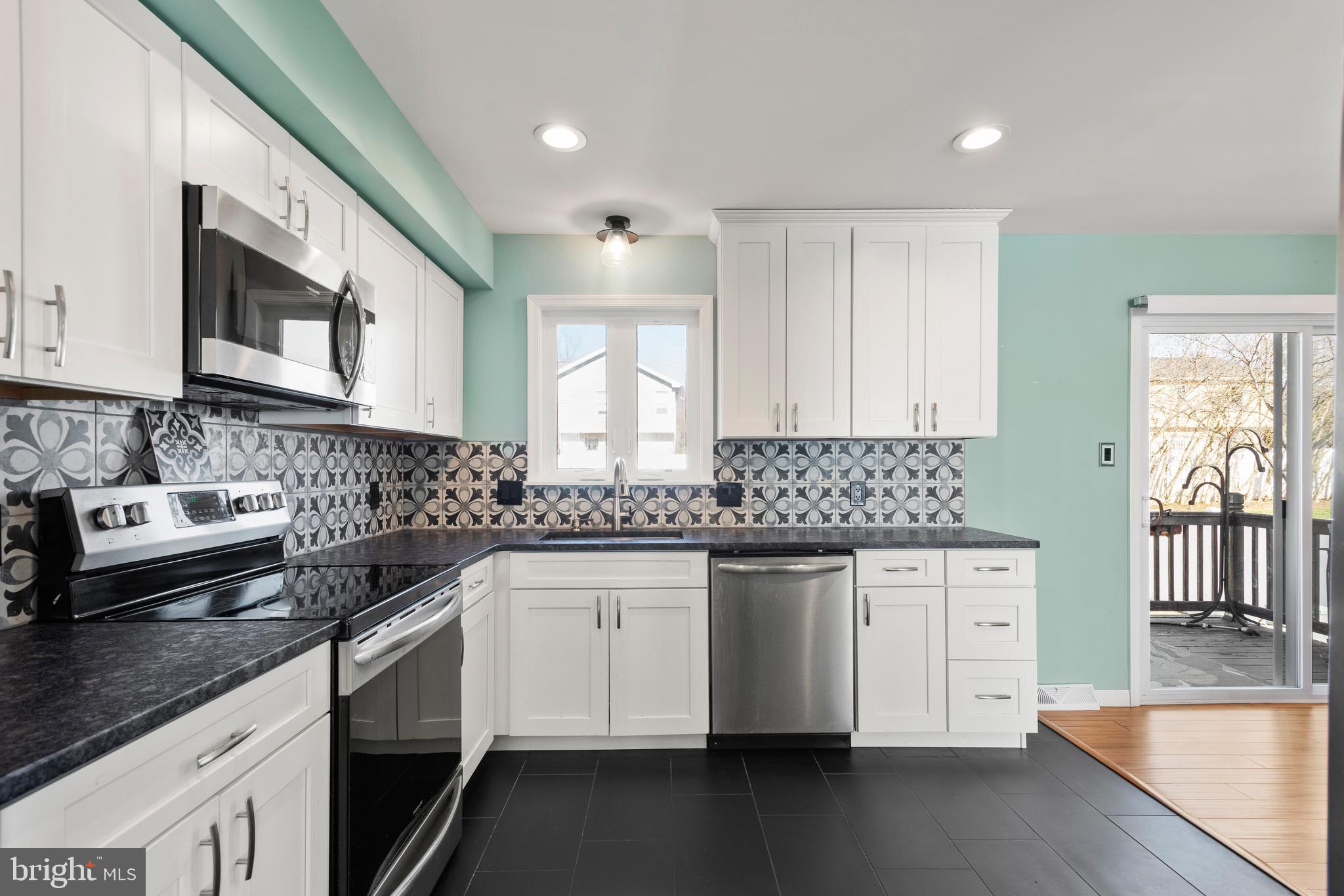 5005 Farming Ridge Boulevard Reading, PA 19606 - Photo 7 of 25 a kitchen with stainless steel appliances granite countertop a sink stove and cabinets