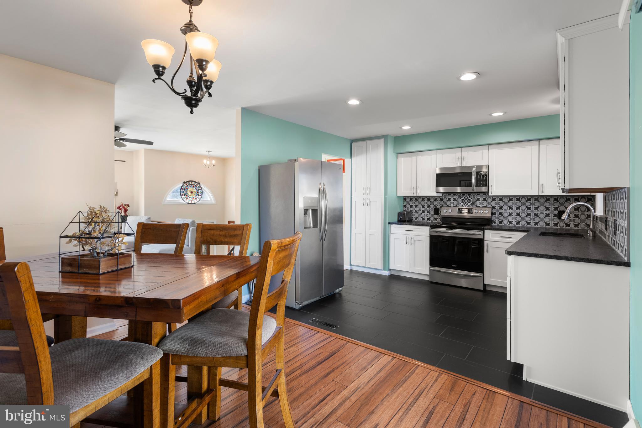 5005 Farming Ridge Boulevard Reading, PA 19606 - Photo 10 of 25 a kitchen with granite countertop kitchen island stainless steel appliances a dining table and chairs