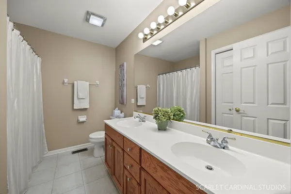 a bathroom with a double vanity sink and a mirror
