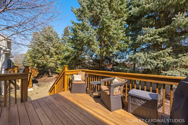 a view of balcony with wooden floor and outdoor seating