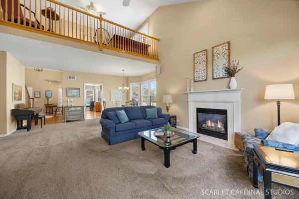 a living room with furniture a fireplace and a table