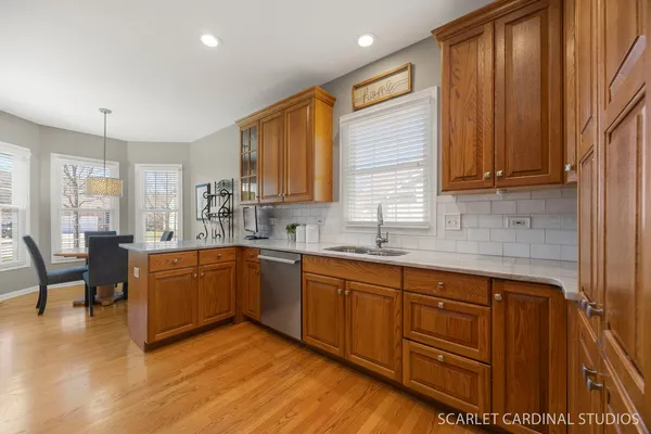a kitchen with wooden cabinets sink and stove