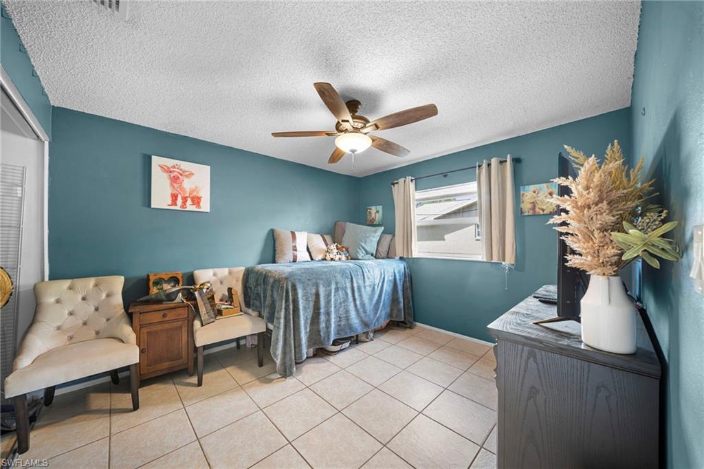 7289 Barragan Road Fort Myers, FL 33967 - Photo 15 of 18 Room featuring tiled flooring, a ceiling fan with integrated lighting, and a single window with blinds