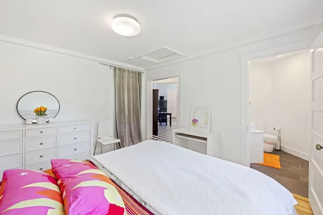 a bedroom with a bed and a dresser