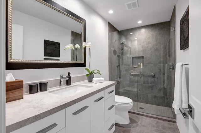 a bedroom with a bed and glass window