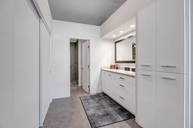 a spacious bathroom with a double vanity sink and a window