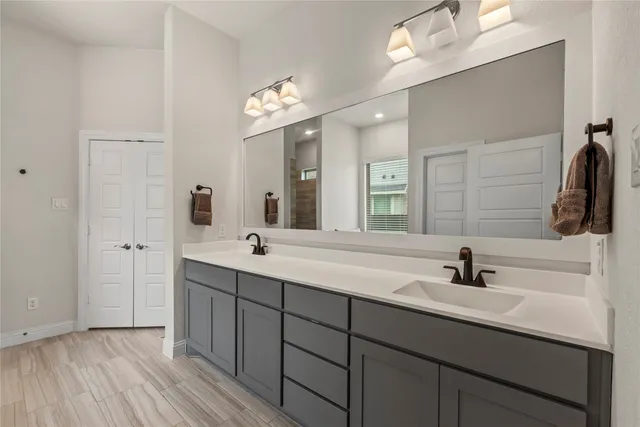 a bathroom with a double vanity sink and a mirror
