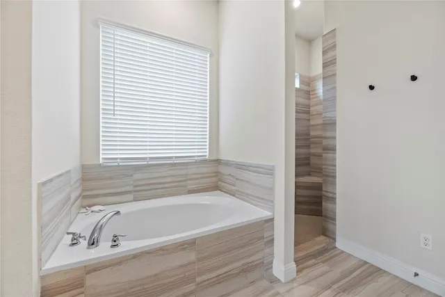 a bathroom with a bathtub and a shower