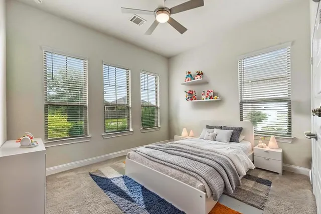 a bedroom with a bed and a large window