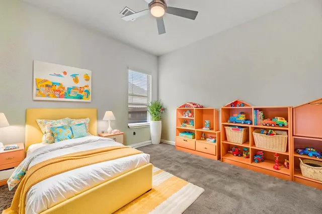 a bedroom with a bed and a book shelf