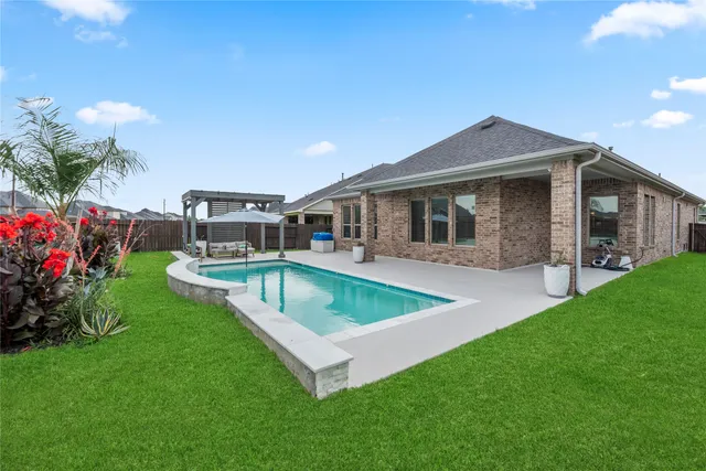 a view of a house with a backyard porch and sitting area