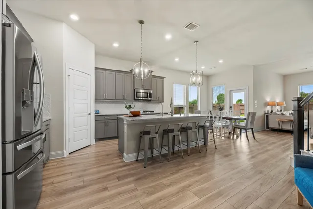 a large kitchen with a table and chairs