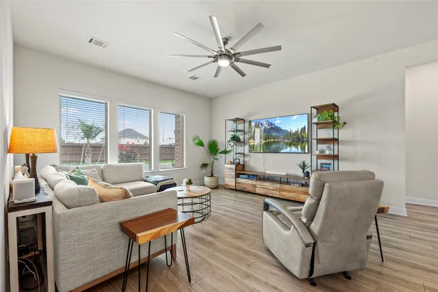 a living room with furniture and a large window