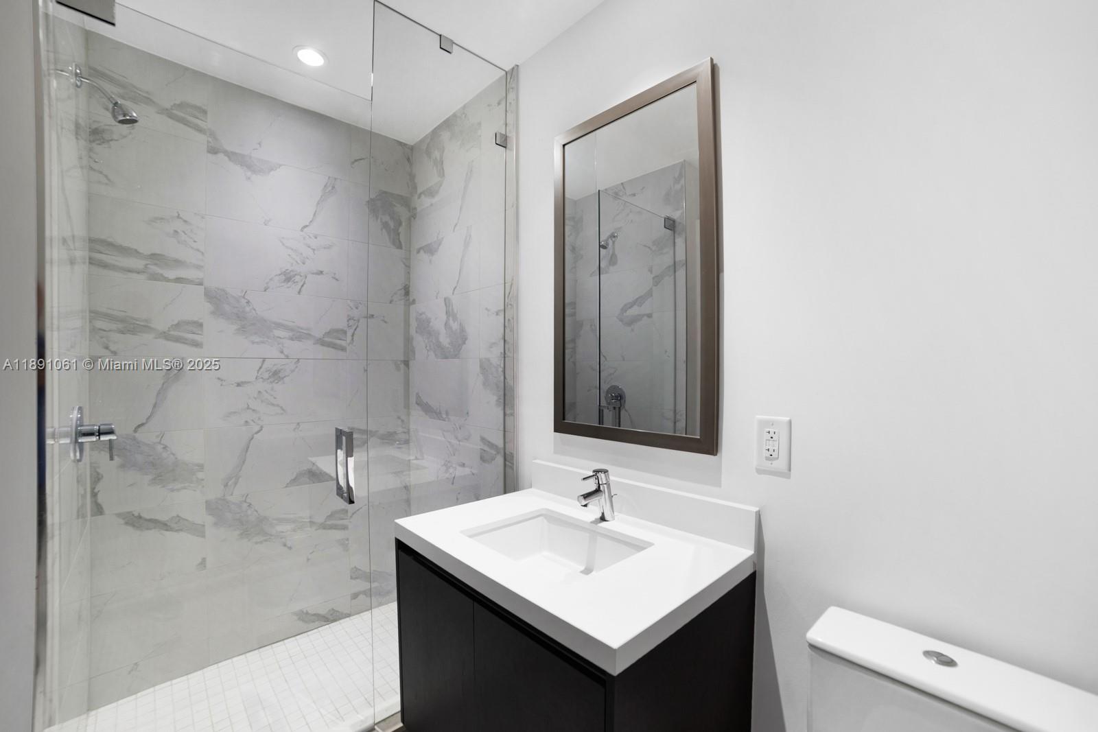 851 Northeast 1st Avenue, Unit 4403 Miami, FL 33132 - Photo 15 of 31 a bathroom with a sink a toilet and shower