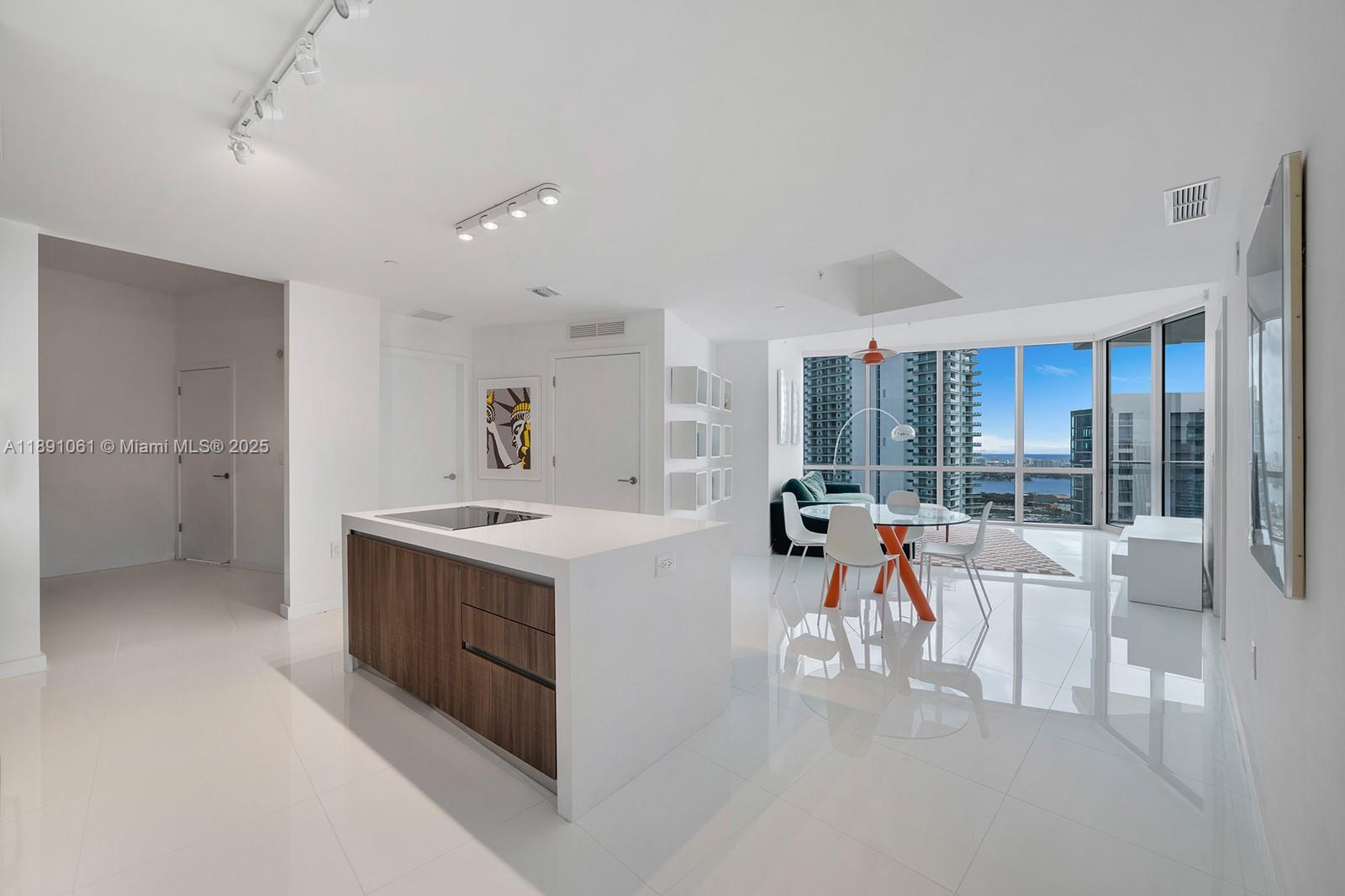 851 Northeast 1st Avenue, Unit 4403 Miami, FL 33132 - Photo 5 of 31 a view of a kitchen with a sink and a refrigerator