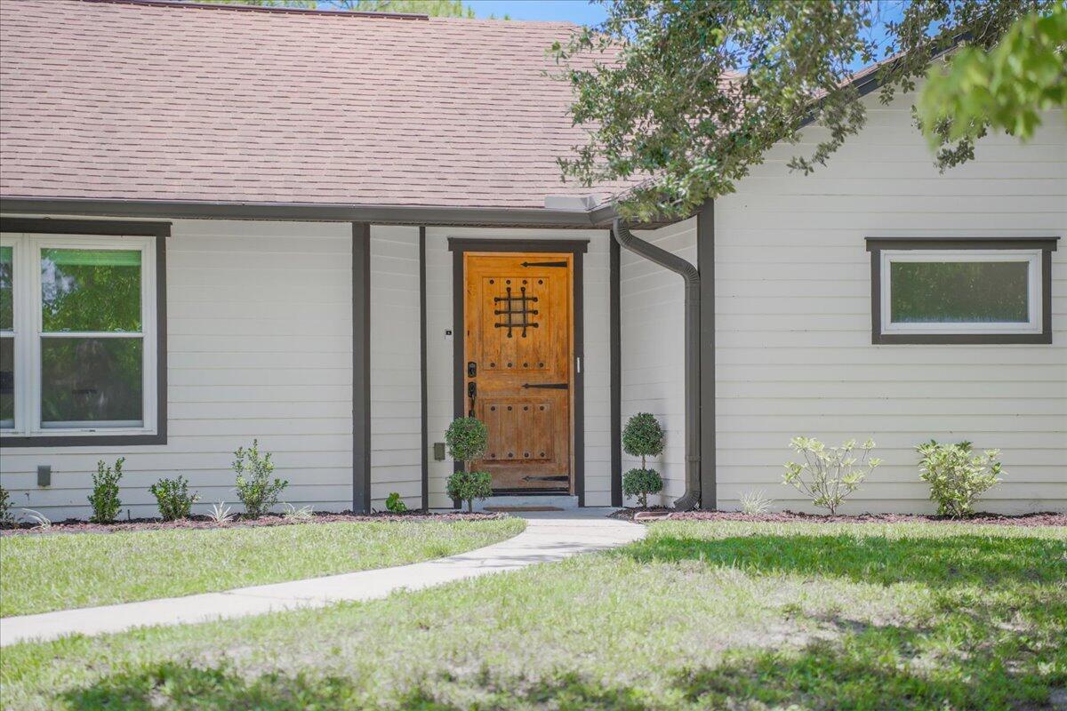 3500 Weber Road Malabar, FL 32950 - Photo 6 of 45 a front view of a house with a garden and plants