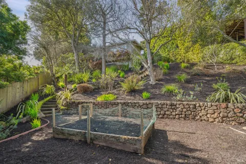 a view of a house with a garage and a yard