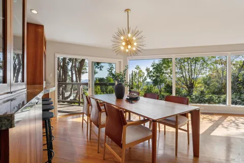 a view of a dining room with furniture window and outside view