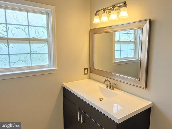 a bathroom with a sink and a window