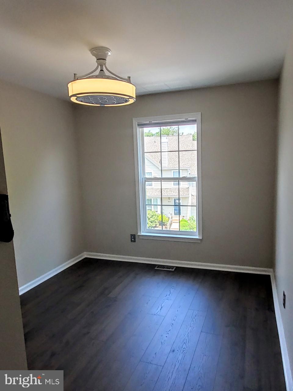 109 Harbour Ridge Lane Downingtown, PA 19335 - Photo 15 of 16 an empty room with wooden floor and windows