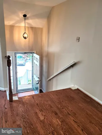 a view of a room with wooden floor and windows