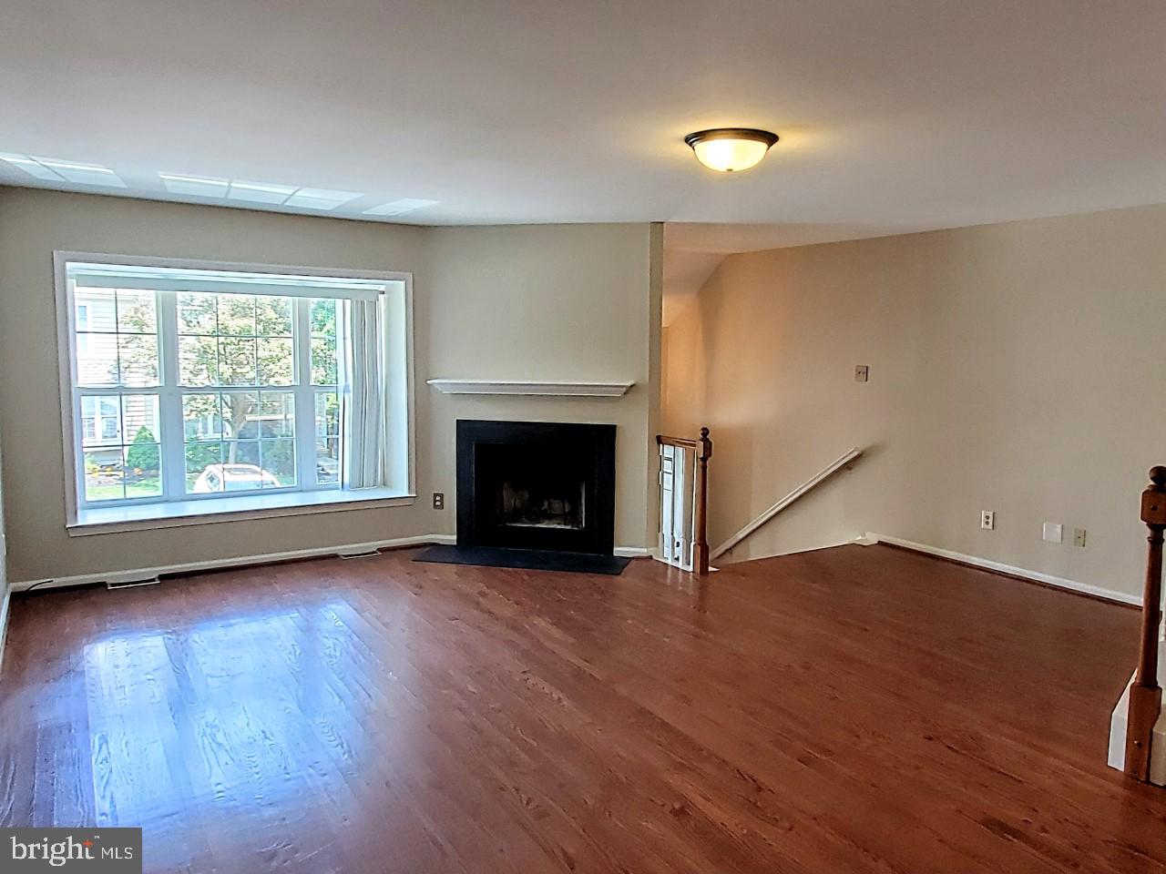 109 Harbour Ridge Lane Downingtown, PA 19335 - Photo 3 of 16 an empty room with wooden floor fireplace and windows