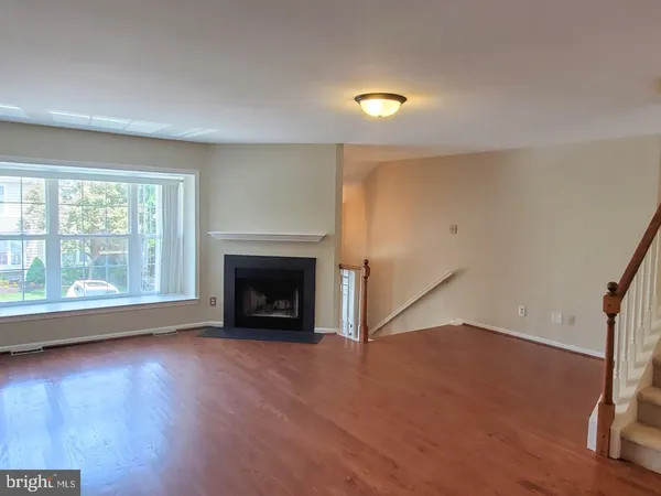 wooden floor in an empty room with a fireplace