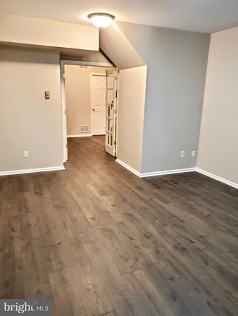 a view of a room with wooden floor