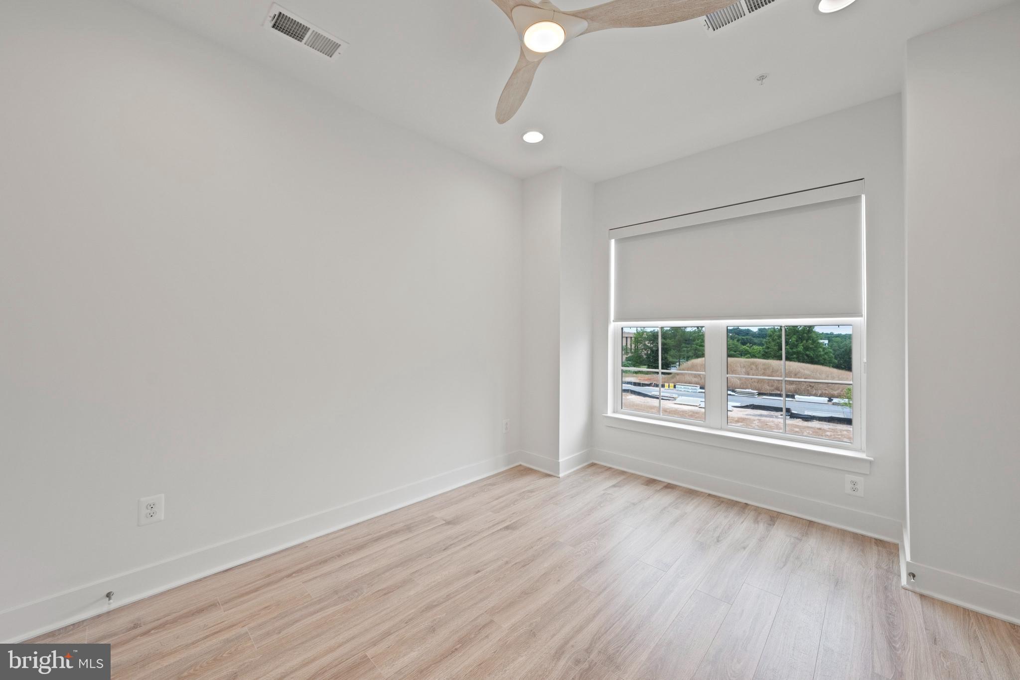 11249 Beaker Street Reston, VA 20190 - Photo 16 of 32 an empty room with wooden floor and windows