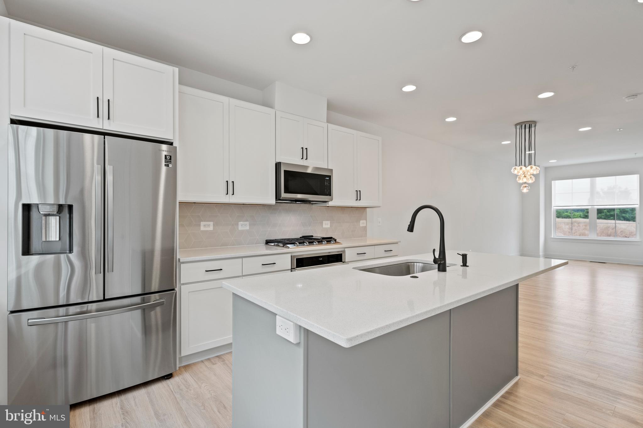 11249 Beaker Street Reston, VA 20190 - Photo 3 of 32 a kitchen with stainless steel appliances a refrigerator stove microwave and sink
