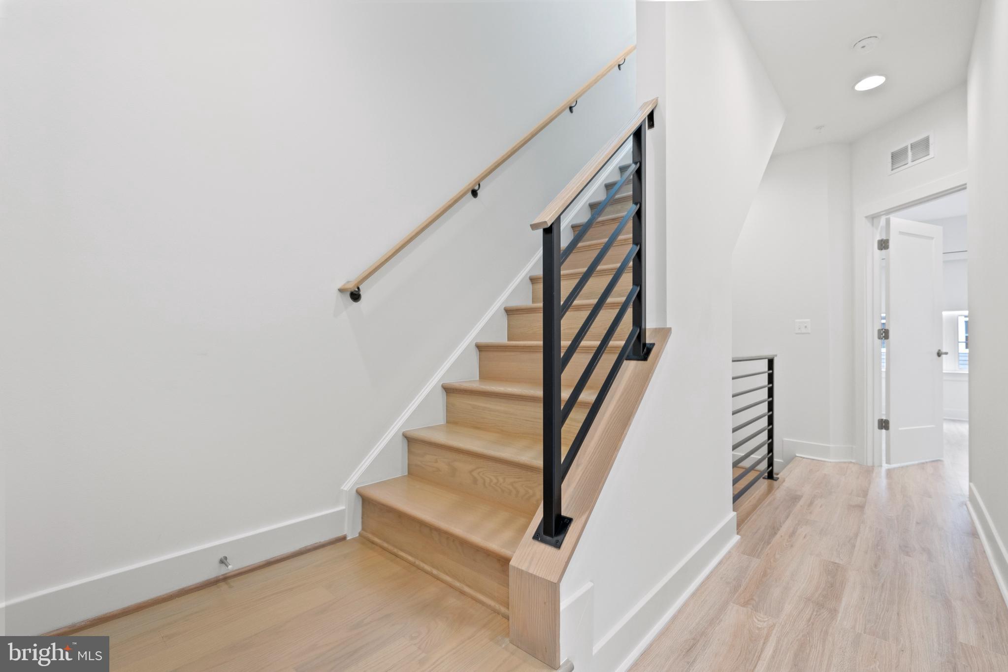 11249 Beaker Street Reston, VA 20190 - Photo 31 of 32 a view of entryway with wooden floor and stairs