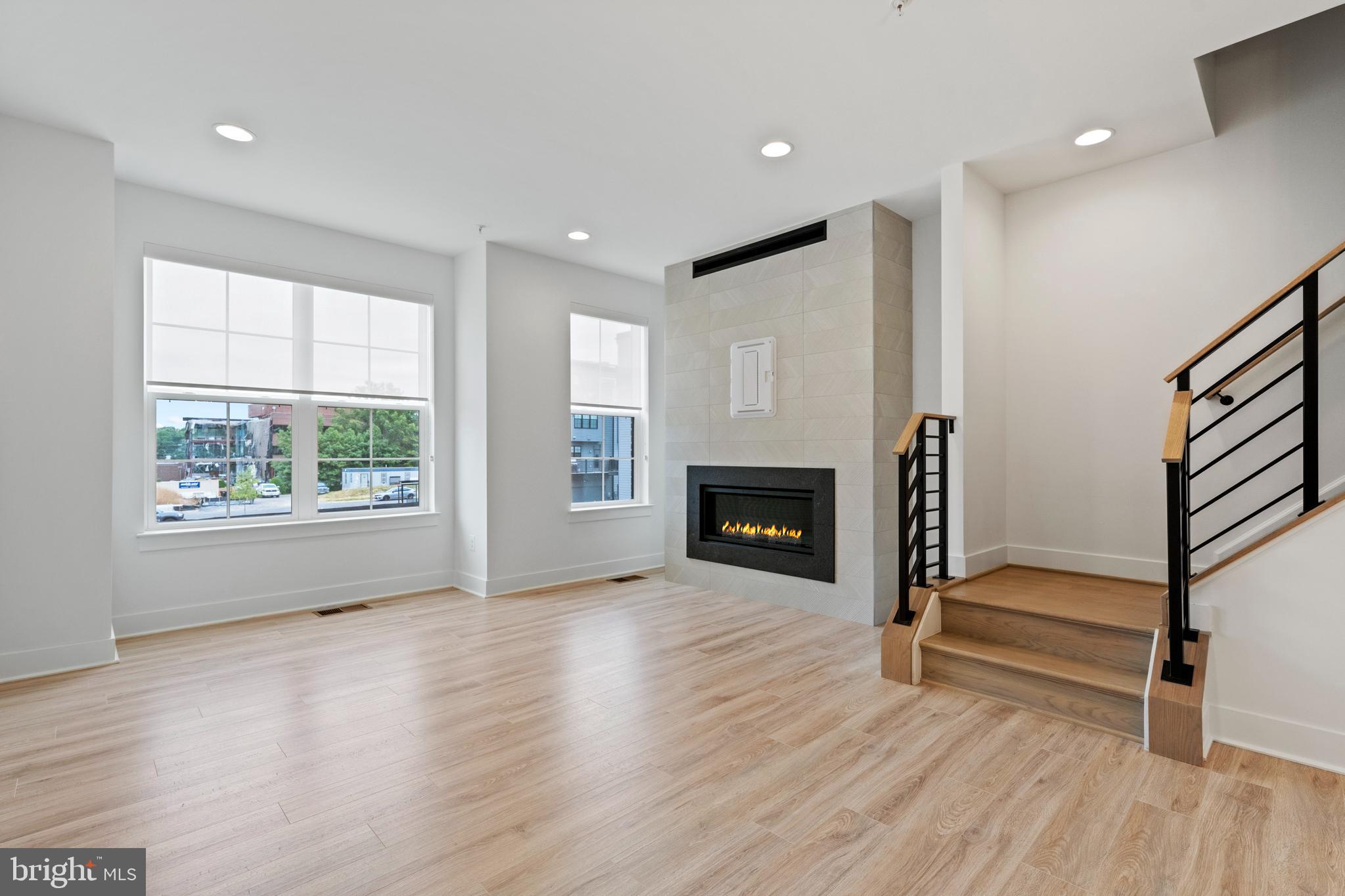 11249 Beaker Street Reston, VA 20190 - Photo 8 of 32 a view of empty room with wooden floor and fireplace