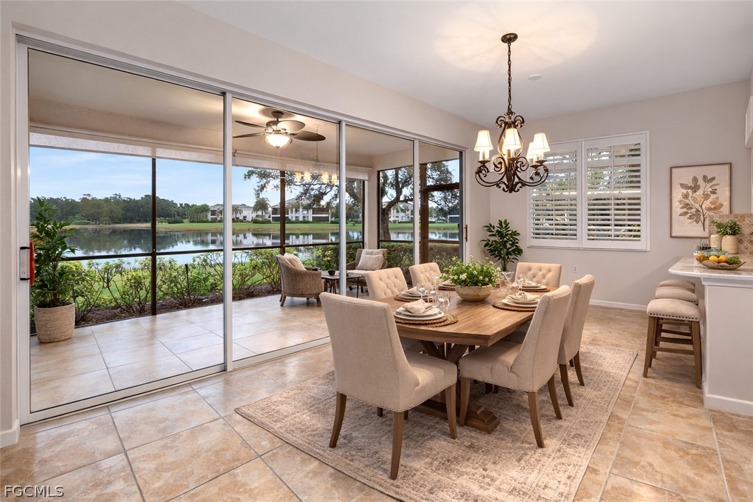 13110 Pebblebrook Point Circle, Unit 102 Fort Myers, FL 33905 - Photo 11 of 35 a view of a dining room with furniture wooden floor and chandelier
