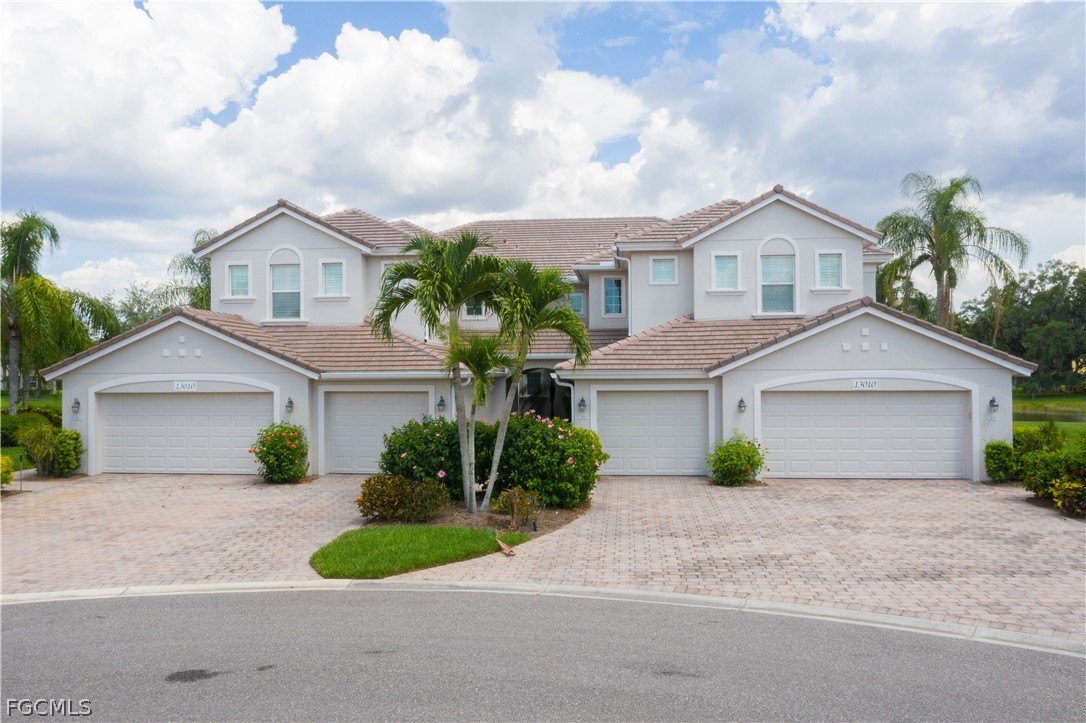 13110 Pebblebrook Point Circle, Unit 102 Fort Myers, FL 33905 - Photo 2 of 35 a front view of a house with a garden
